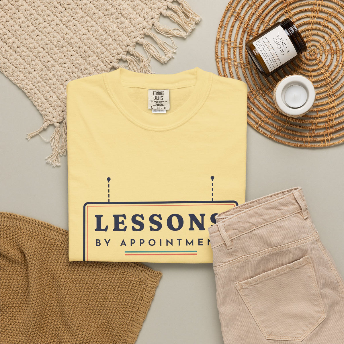 Lessons by Appointment Tee in Butter, flat lay