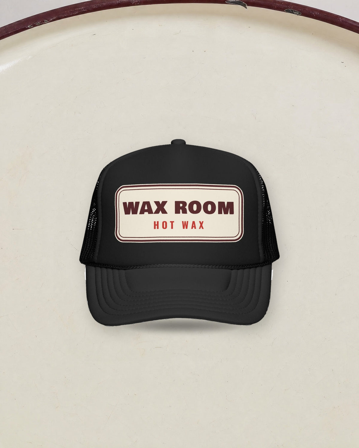 Wax Room Trucker Hat in Black, styled