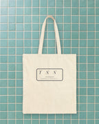 Monogram Shield Tote in Natural, styled