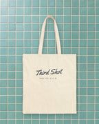 Script Chest Mark Tote in Natural, styled